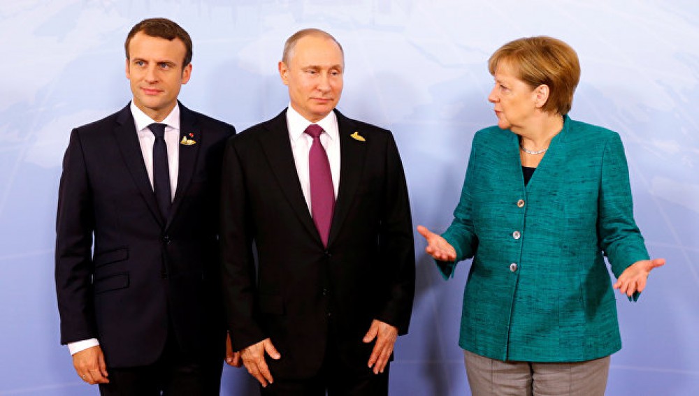 بوتين وميركل وماكرون وبوروشينكو