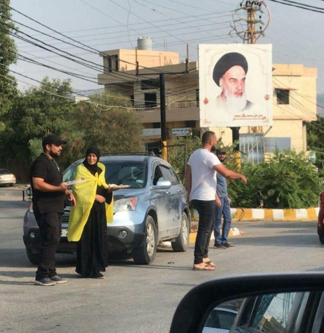  والدة اللبناني المقتول توزع حلويات بعد قصف إسرائيل