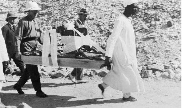 هوارد كارتر وعمال يحملون أجازاء من قبر الملك توت عنخ آمون