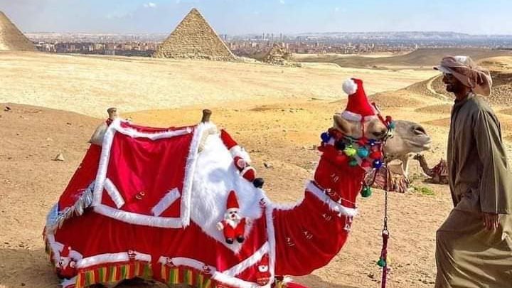 الجمال ترتدي زي بابا نويل في الأهرامات 