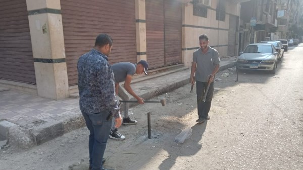  إزالة التعديات والحواجز الحديدية بالشوارع بأسيوط 